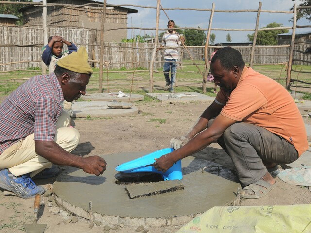 Masons constructing toilet slabs