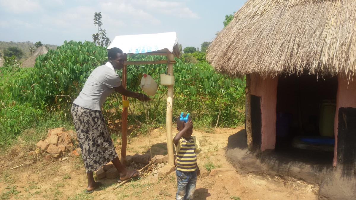 Christine of Iuya village demonstrates the use of tippy tap