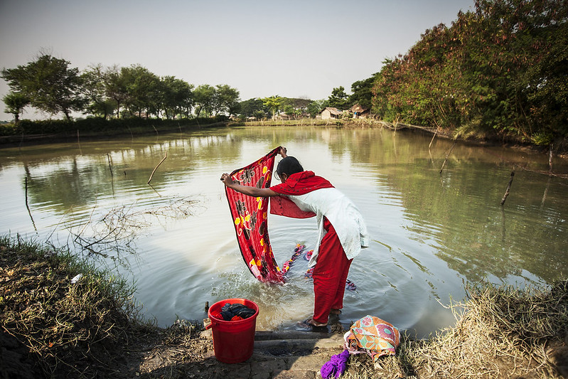 Daily laundry - Women washing clothes in river, Bangladesh